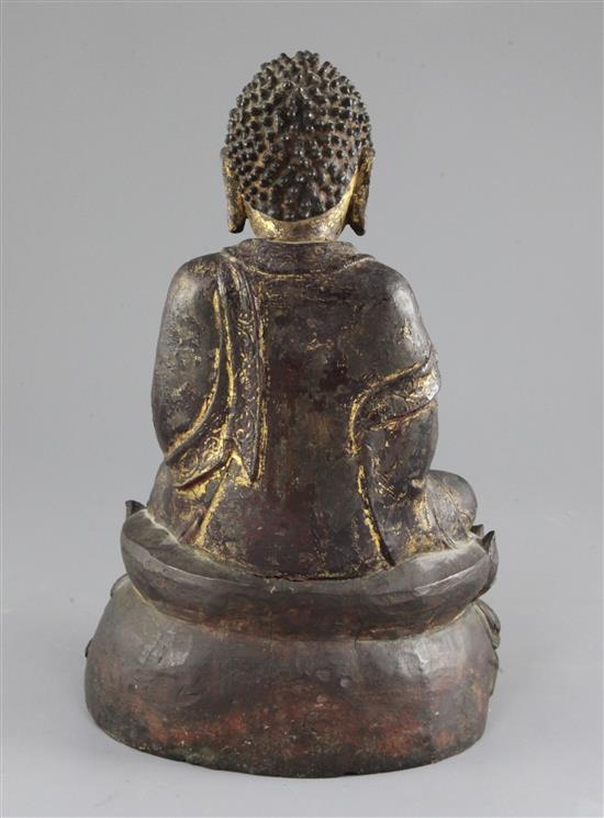 A Chinese gilt-lacquered bronze seated figure of Buddha Shakyamuni, early 17th century, 30cm, By repute purchased from Bluetts